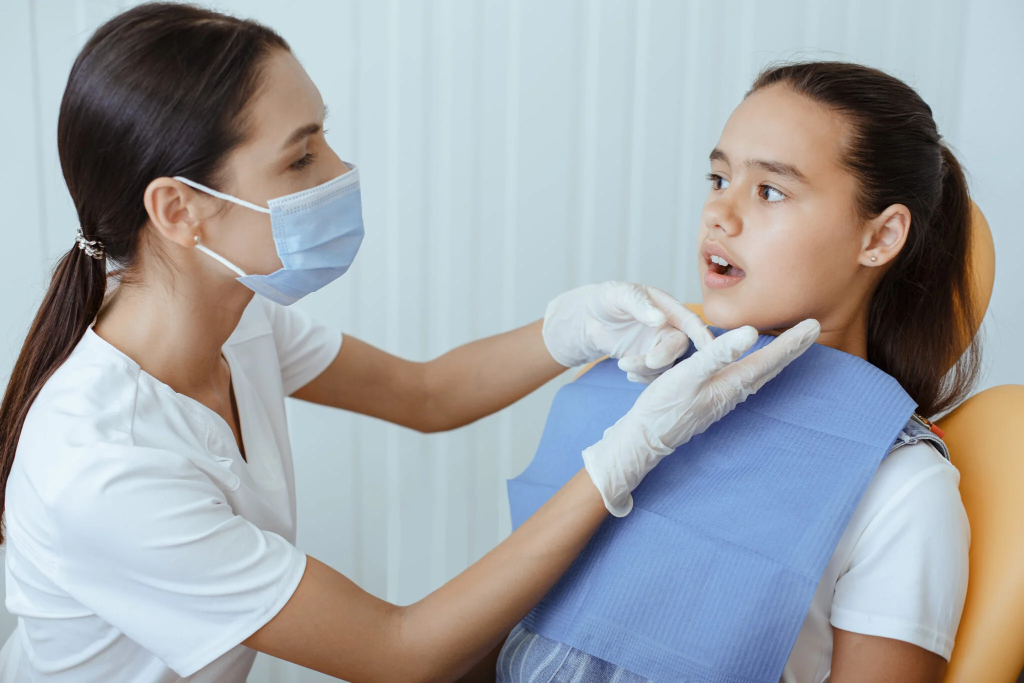 pediatric dentist making examination procedure